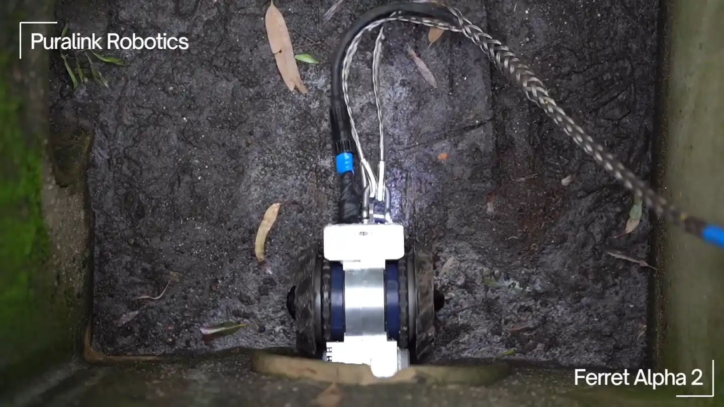 Ferret Alpha 2 in the field: a drone view of a deployment, the crew, the robot's in-pipe cameras and the Basestation — looping footage