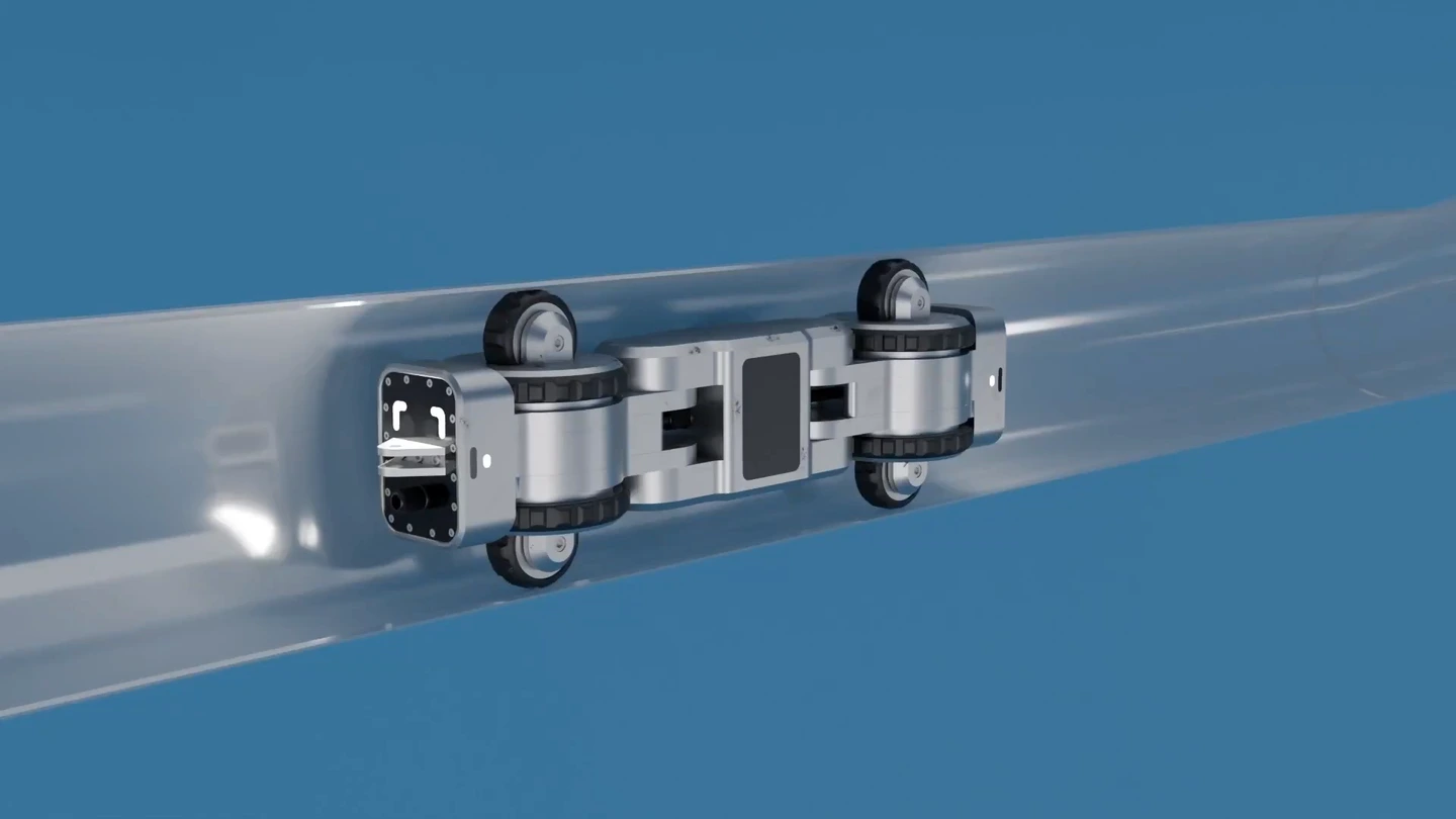 A 3D render of the Ferret driving through a cut-away pipe, taking the bends into a vertical run